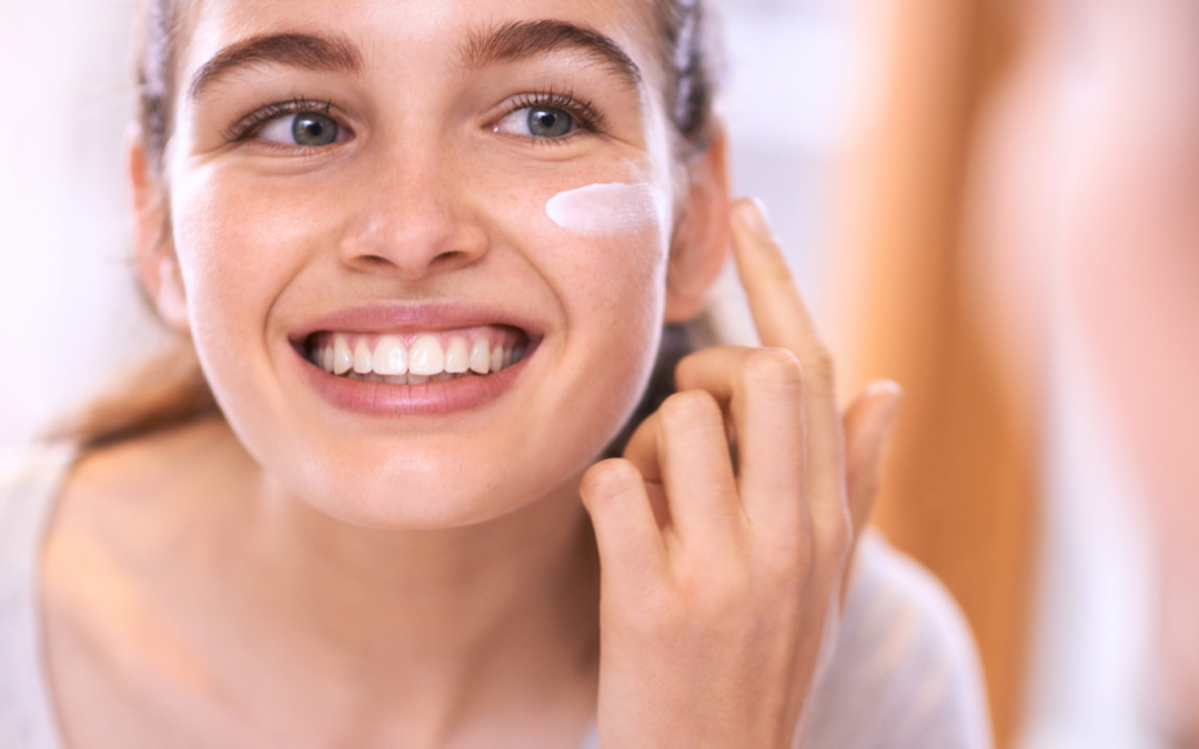 Teen girl applying sunscreen to her face for sun safety