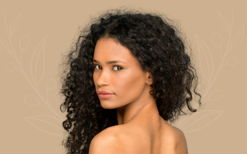 Headshot of a woman looking over her shoulder after aesthetic treatments