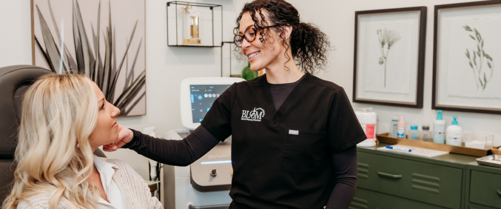 Is Laser Hair Removal Worth It? Myths & Facts – Bloom MedAesthetics Woman speaking with professional at Bloom MedAesthetics about laser hair removal process.