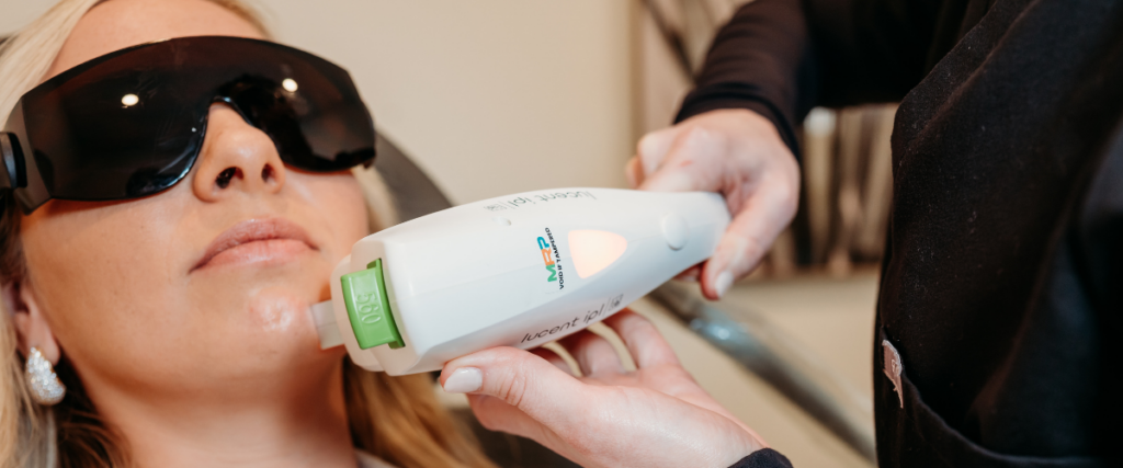 Is Laser Hair Removal Worth It? Myths & Facts – Bloom MedAesthetics Bloom MedAesthetics performing a laser hair removal procedure on a woman's chin